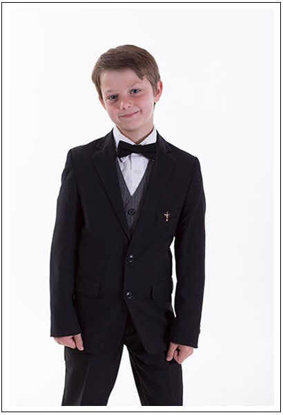 Boy wearing tuxedo and posing at kids photography session